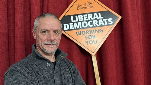 Greg stood in front of Lib Dem Stake Board