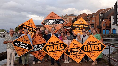 Lib Dem Members & Supporters all standing behind Graham, the new Lib Dem Candidate for Bridgwater holding up Lib Dem signs.